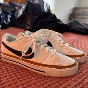 Nike White Low-Top Sneakers with Black Swoosh and Brown Trim